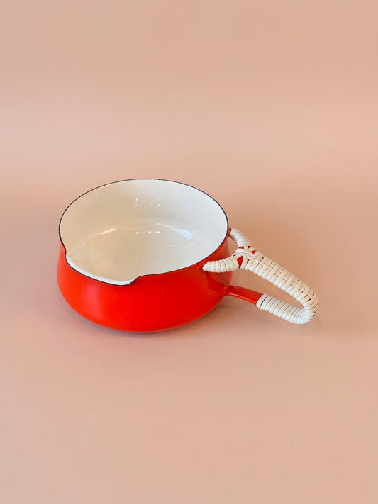 Red Dansk Kobenstyle butter warmer with white interior, pouring lip, and light-colored wrapped loop handle